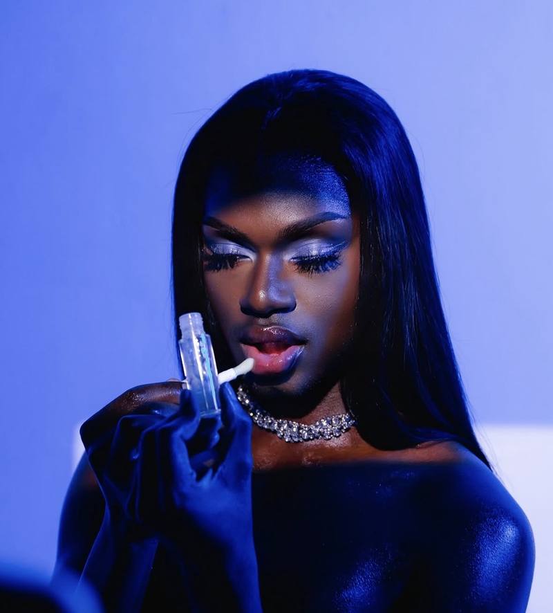Model under blue light applying clear gloss